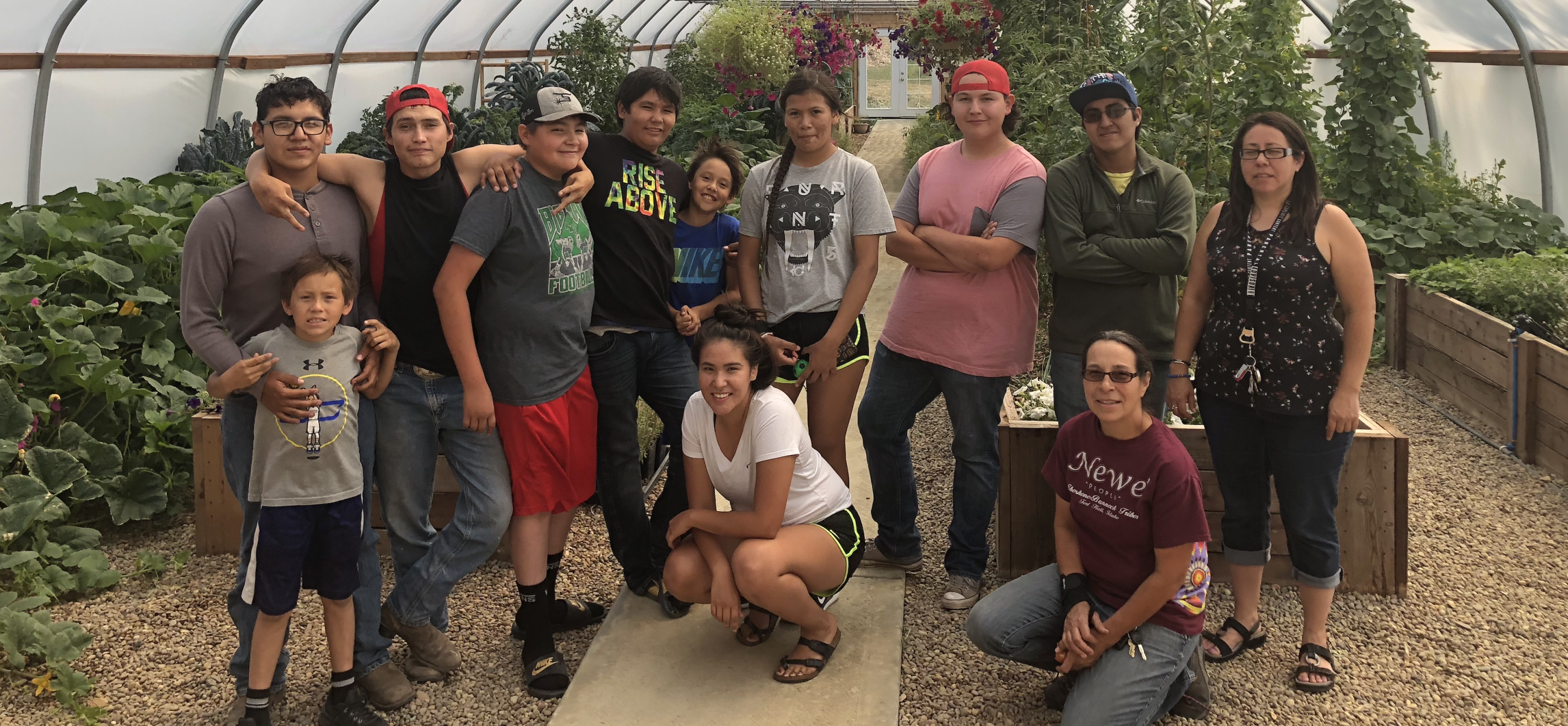 Group photo of Fort Belknap Native youth in a community garden.